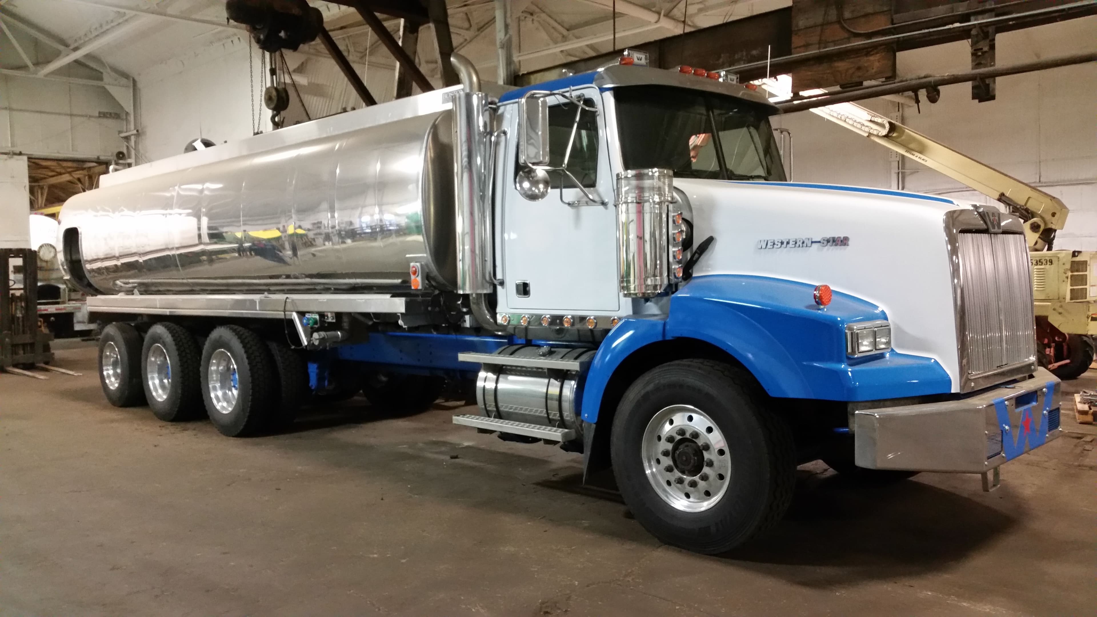 Polished stainless tri-axle tank mounted on a freshly rechassised Western Star straight truck inside the Schaeffer shop
